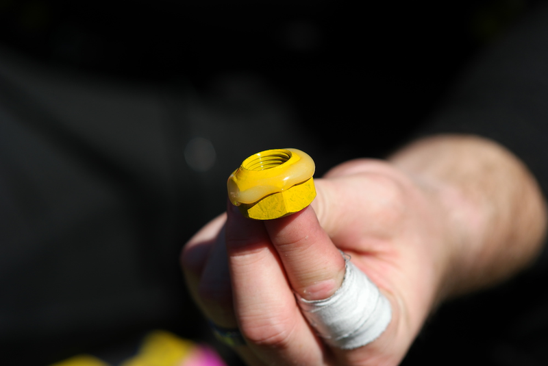 Glue on a lug nut, which a tire changer would then attach to a wheel.